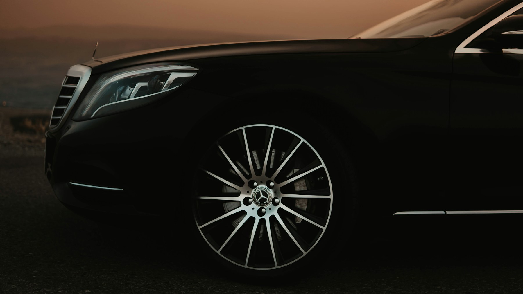 An executive black vehicle in warm evening light